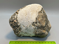 a white vein of fine white crystalline quartz cutting throug a darker crystalline rock 